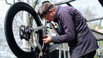 Bicycle mechanic repairing a bike in his workshop