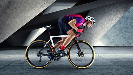 Portrait of man, professional cyclist training, riding on professional sport bike around city