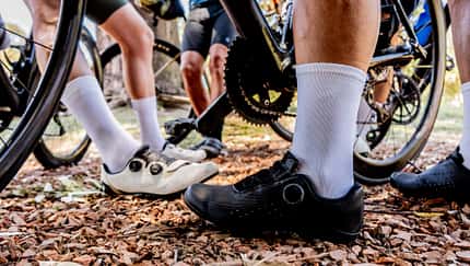 Low section of cyclists preparing for ride on autumn trail Low section of cyclists preparing for ride on autumn trail