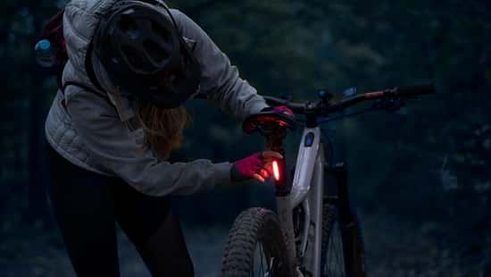 Young woman on a night e-bike ride