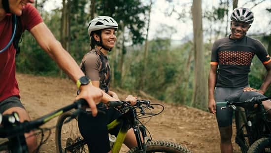 Group of friends cycling together in the nature