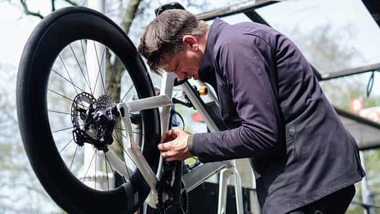 Bicycle mechanic repairing a bike in his workshop