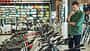 man checking out bicycles in bike shop