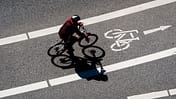 High Angle View Of Man Cycling On Bicycle Lane During Sunny Day