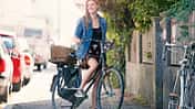 Young woan with bicycle in the city