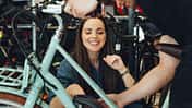 Man showing customer new e-bike in bike shop