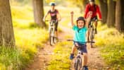 Happy family cycling in the countryside