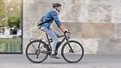 Mann pendelt mit seinem E-Bike zur Arbeit