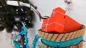 Magic Christmas bicycle with gifts and pine tree on background