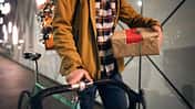An unrecognizable delivery guy delivering Christmas gifts and orders