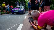 A man is seen taking a photo from below of one of the