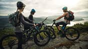 Group of friends mountainbike riders: MTB biking outdoor up mountain of Norway